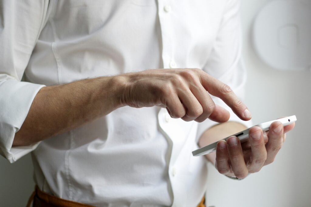 Person pointing on their phone.